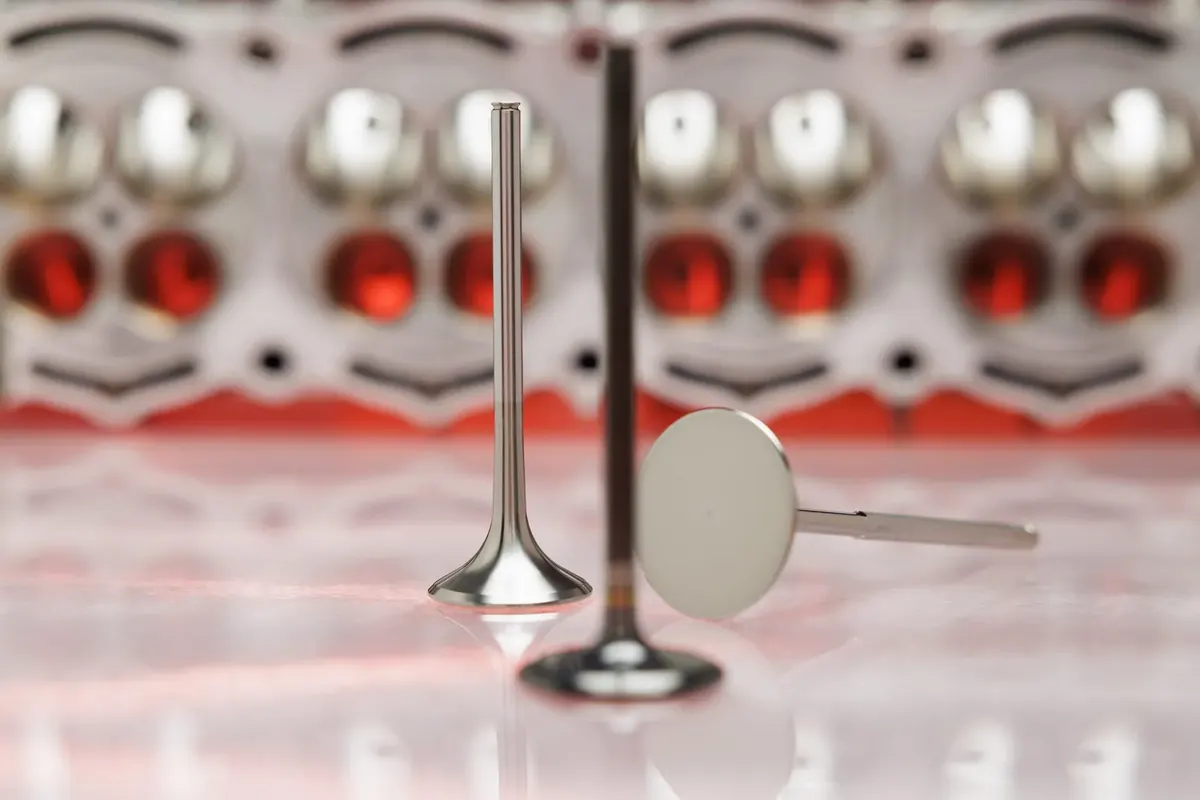 Titanium racing valve in front of a cylinder head