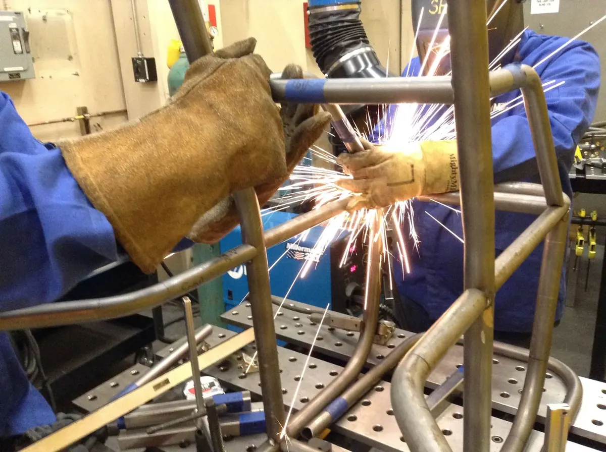 Welding the Baja chassis, sparks flying